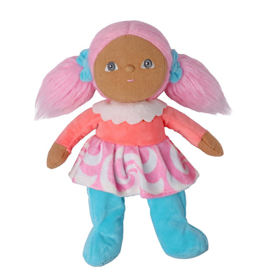 A plush doll with brown fabric skin, pink yarn hair styled in pigtails with blue bows, wearing a pink and white patterned dress and blue boot covers, isolated on a white background.