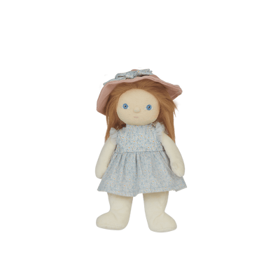 Stuffed doll with a pink hat and light blue dress on a black background