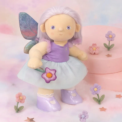Fairy doll with purple outfit and butterfly wings on a pastel background