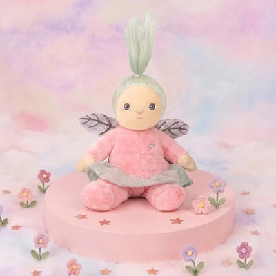 Dinky Dinkums Fifi Fairy plush doll in a pink outfit with silver skirt and translucent wings seated on a pink display surrounded by pastel flowers