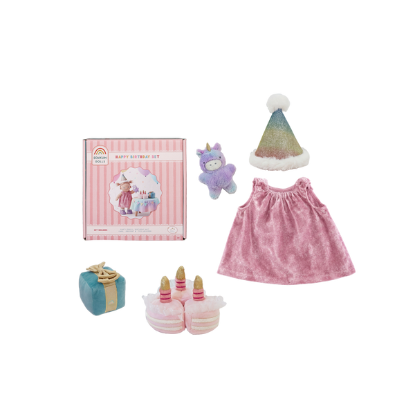 Collection of children's items including a pink dress, hat, toy, and cake set on a white background.