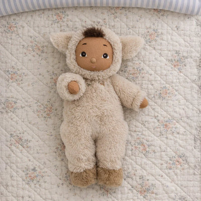 Cozy Day Dinkum Lamby Tig plush doll in a soft cream lamb outfit lying on a floral quilt with a warm brown face and fluffy ears