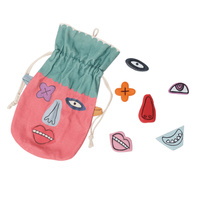 Olli Ella Kids Loopy Lucy sensory stones in a drawstring pouch with interchangeable eyes nose mouth and colorful facial pieces for imaginative play