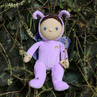 Dinky Dinkums purple butterfly soft doll with curly antennae delicate wings and embroidered rainbow detail posed among leafy garden foliage