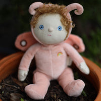 Dinky Dinkums Millie Moth plush doll with pink antennae curly hair blue eyes soft wings and a rainbow detail sitting in a garden planter