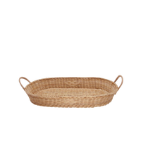 Handwoven natural rattan changing basket with sturdy handles for a cosy nursery from Olli Ella Nursery