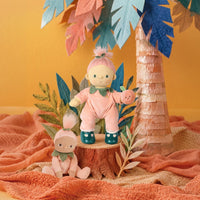 Dream Dinkum doll Piper Peach in a peach romper holding a pink fruit beside a smaller doll in a colourful Mumble Jungle play scene by Olli Ella