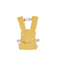 Buttercup yellow Dinkum Dolls Petal Carrier with scalloped edges and adjustable shoulder straps for imaginative doll play