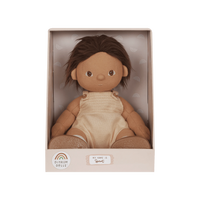Doll in a beige box with a label on a white background