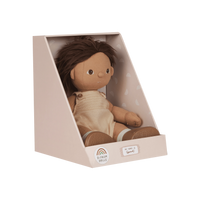 Doll in a beige box with a white background
