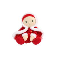 Plush doll with red hair, embroidered green eyes and rosy cheeks, wearing a red velvet hooded cape with white fluffy trim over a red outfit with a tulle skirt, white fluffy cuffs and a small rainbow patch on the chest.