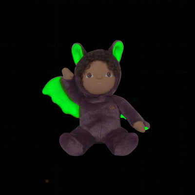 Purple bat themed Dinky Dinkums doll with bright green wings and ears seated against a black background in a soft plush design