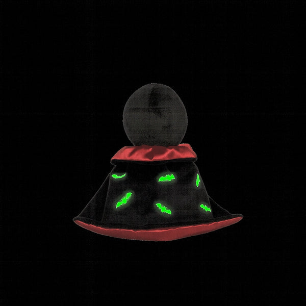 Stuffed toy with a black glow in the dark hood and red trim on a white background