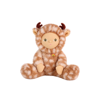 Plush doll in a fluffy fawn-print deer suit with cream spots, small brown velvet antlers and soft ears, a smooth fabric face with embroidered green eyes, and a tiny rainbow patch on the chest.