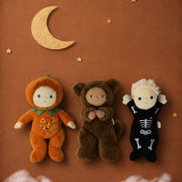 A brown plush teddy bear doll wearing a furry animal hood with small ears