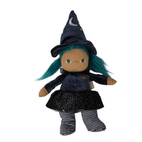 A witch doll plush toy with teal hair, wearing a navy blue velvet hat with a crescent moon and star, a navy long-sleeve top, a black sparkly skirt, and black-and-white striped socks, shown on a plain white background.