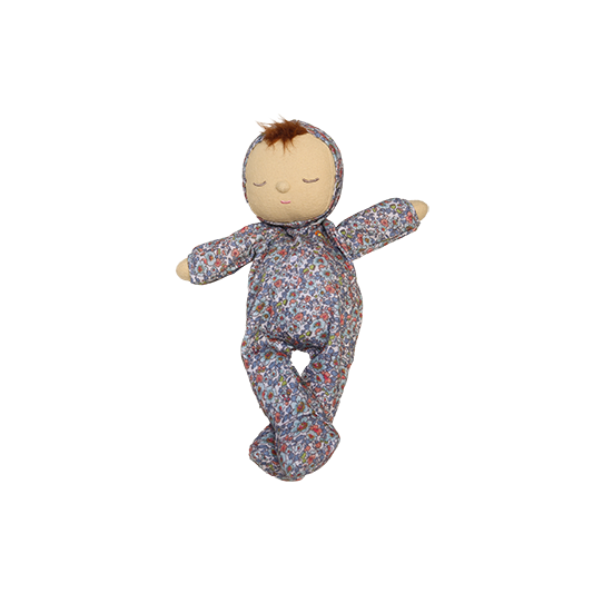 Stuffed doll in a floral outfit on a white background