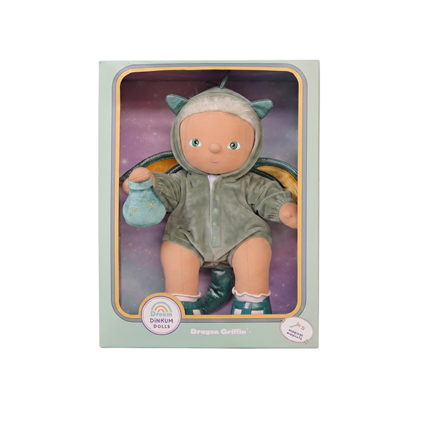 Doll in a dragon costume with packaging on a white background