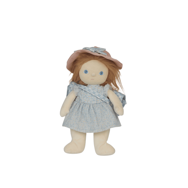 Stuffed doll with a blue dress and pink hat on a black background