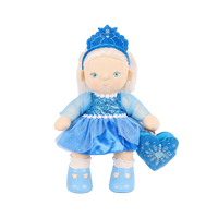 Plush doll with white hair, blue eyes and rosy cheeks, wearing a blue velvet tiara, a sequinned blue dress with sheer sparkly sleeves and a tulle skirt, white frilled socks, light blue shoes, and a blue heart-shaped bag with an embroidered snowflake.