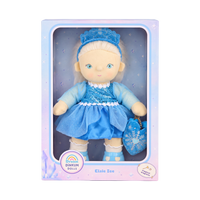 Plush doll in a box with white hair, blue eyes and rosy cheeks, wearing a blue velvet tiara, a sequinned blue dress with sheer sparkly sleeves and a tulle skirt, white frilled socks, light blue shoes, and a blue heart-shaped bag with an embroidered snowflake.