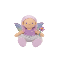 Plush fairy doll with pink hair, wings, and a flower on a white background