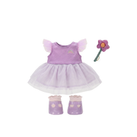 Purple dress with matching shoes and a pink wand on a white background