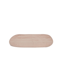 Soft rose organic cotton liner with rounded edges for an Olli Ella changing basket shown flat on a black background