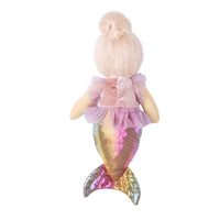 A plush mermaid doll viewed from the back, featuring blonde hair in a bun, a pink ruffled top, and an iridescent gold and pink tail, set against a plain white background.