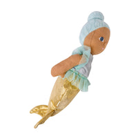 A mermaid doll plush toy with a light blue hair bun, brown skin, a light blue and gray top, and a shimmering gold tail, shown against a plain white background.
