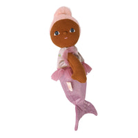 A small mermaid doll with brown skin sideways