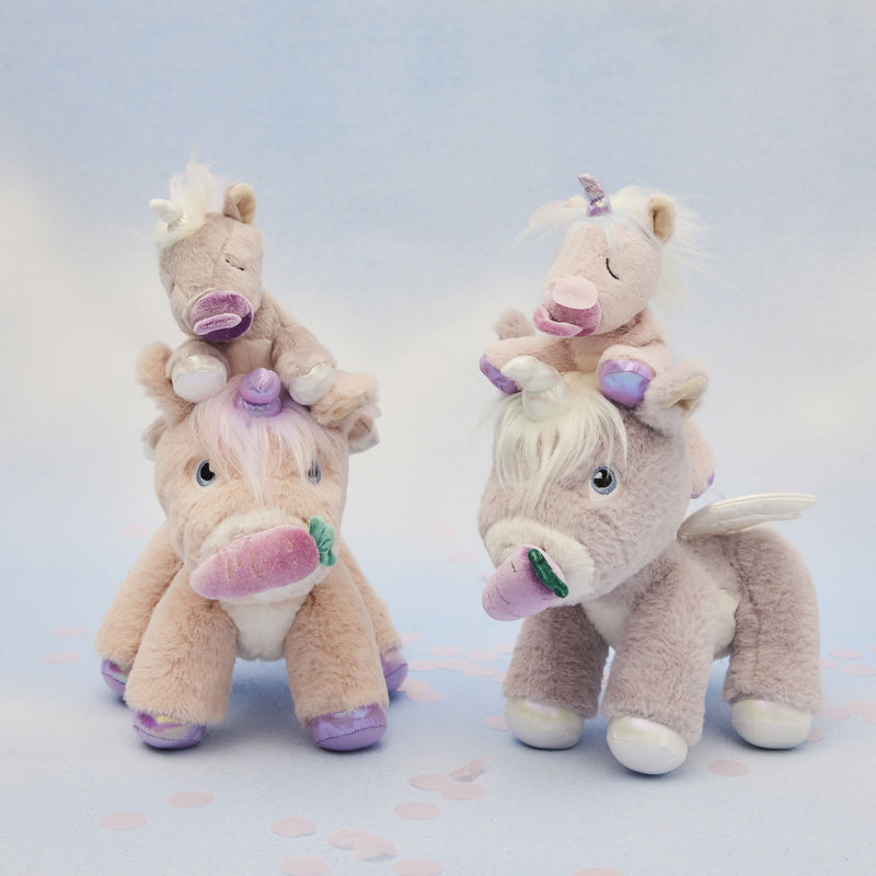Two soft pastel plush unicorn toys with tiny unicorn companions perched on their heads featuring pink and purple details Dinkum Pets imaginative play companions