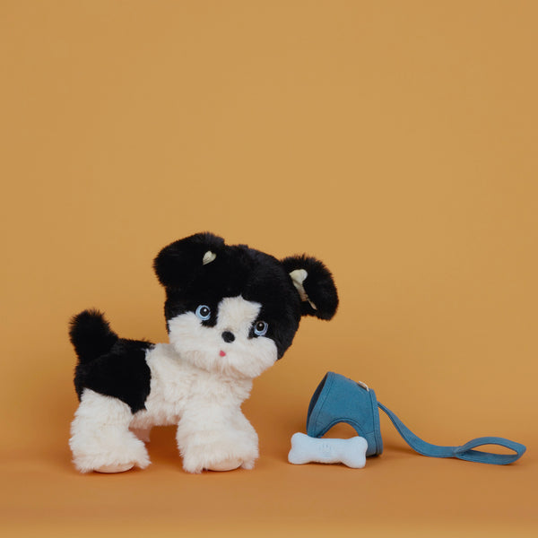 Olli Ella Dinkum Dog Lucky - black and white dog with blue bone and harness