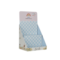 Dinky Dinkums Fluffle Family cardboard display stand with blue and white gingham panels and playful illustrated floral artwork along the base