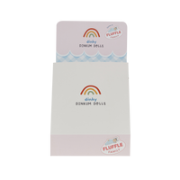 Pastel Dinky Dinkums Fluffle Family packaging with rainbow branding and scalloped pink and blue details on a white box front and lid