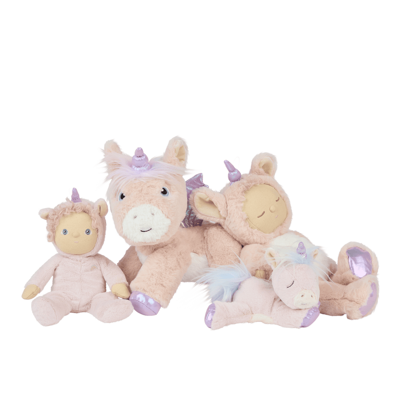 Dinky Dinkums Una Unicorn plush doll shown with soft pink unicorn friends in a playful group portrait featuring tactile fabrics and pastel details