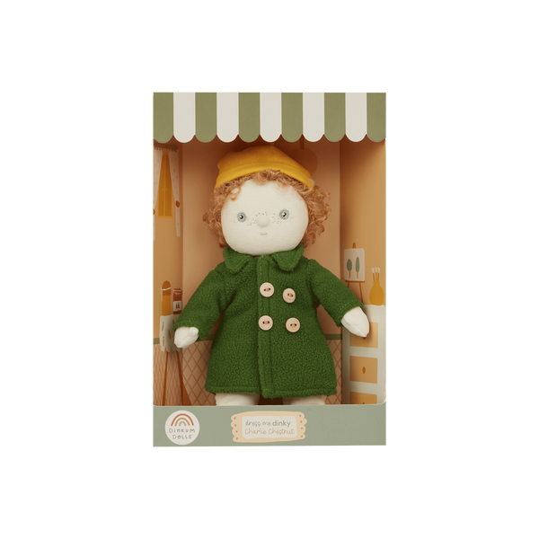 Stuffed toy with a green coat and yellow hat in packaging