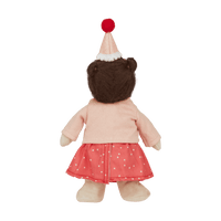 back of a doll with hat, pink cardigan and spot dress
