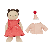 doll in a spot dress with hat and pink cardigan beside it