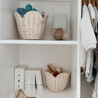 Olli Ella Nursery buttercream rattan lily basket set displayed on nursery shelves with toys books and baby accessories neatly stored inside