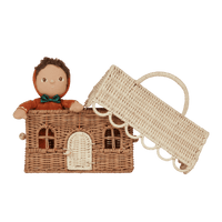 Olli Ella rattan gingerbread house clutch with woven handle and openings beside a small doll in a festive brown outfit