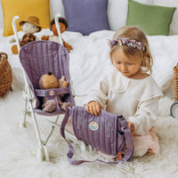 Child playing with a lavender doll stroller and matching changing bag while a doll sits inside on a soft bedroom rug from Olli Ella Dinkum Dolls