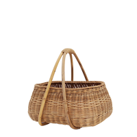 Natural rattan basket with woven texture and bamboo handles from Olli Ella Lifestyle for market trips toy storage or everyday home essentials