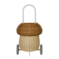 Natural rattan mushroom shaped luggy basket with two tone woven body arched handle and two wheels by Olli Ella Kids Rattan for imaginative play