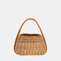 Woven rattan basket with a rounded shape and tall bamboo handle from Olli Ella Lifestyle for market trips toy storage and everyday essentials