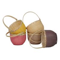 Olli Ella woven bamboo baskets in berry pink and natural tones with loop handles arranged together for imaginative play and carrying treasures
