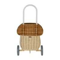 Natural rattan mushroom luggy basket with a woven top handle and two wheels for imaginative play and carrying favourite toys onderweg